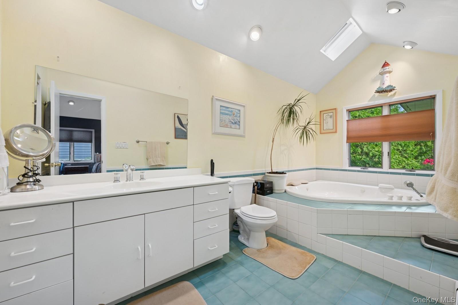 101 Bay Street Long Beach, NY 11561 - Photo 22 of 42 a bathroom with a toilet a sink a tub and mirror
