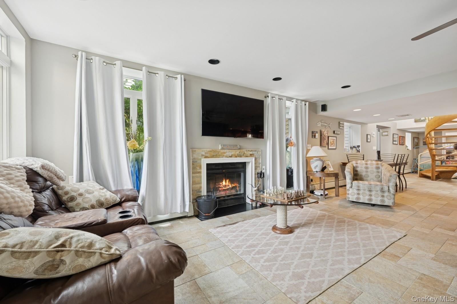 101 Bay Street Long Beach, NY 11561 - Photo 26 of 42 a living room with furniture a flat screen tv and a fireplace