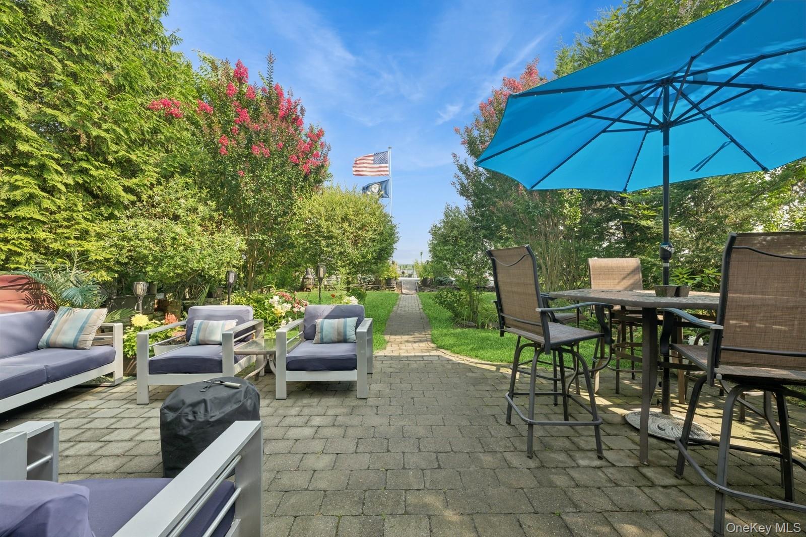 101 Bay Street Long Beach, NY 11561 - Photo 28 of 42 a view of a patio with couches under an umbrella