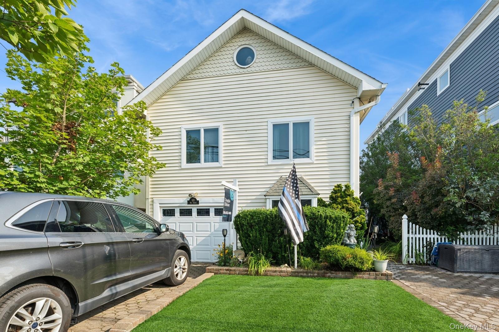 101 Bay Street Long Beach, NY 11561 - Photo 3 of 42 a front view of a house with a yard