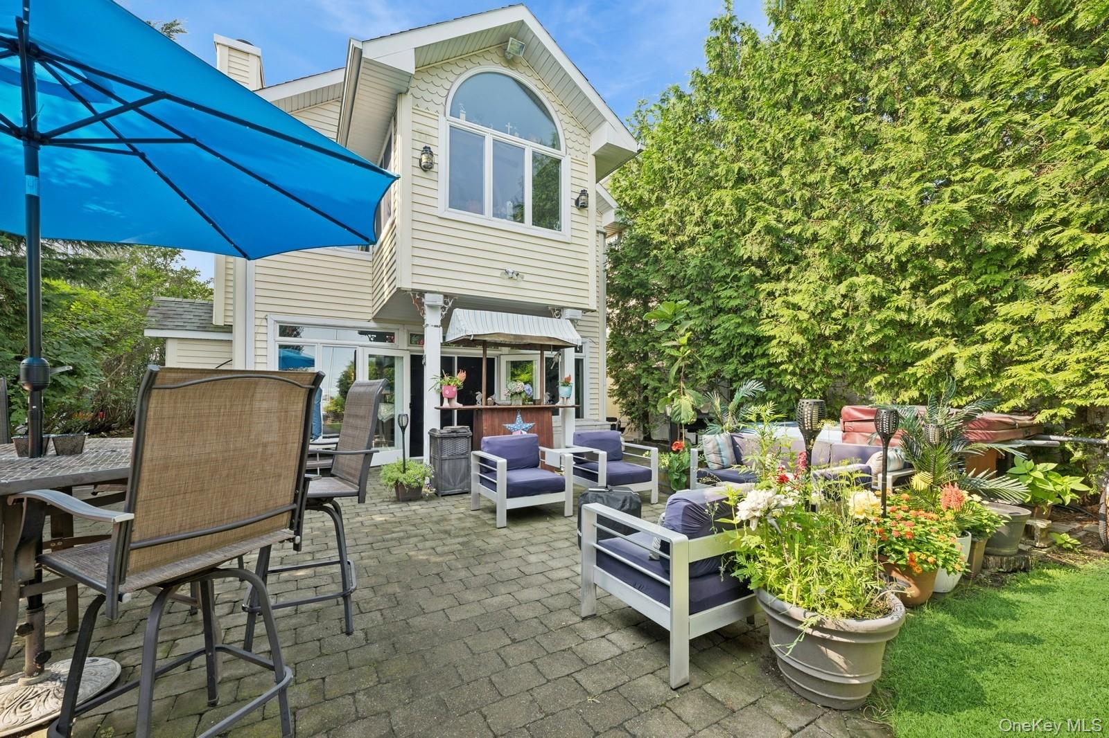 101 Bay Street Long Beach, NY 11561 - Photo 4 of 42 a view of a patio with table and chairs under an umbrella