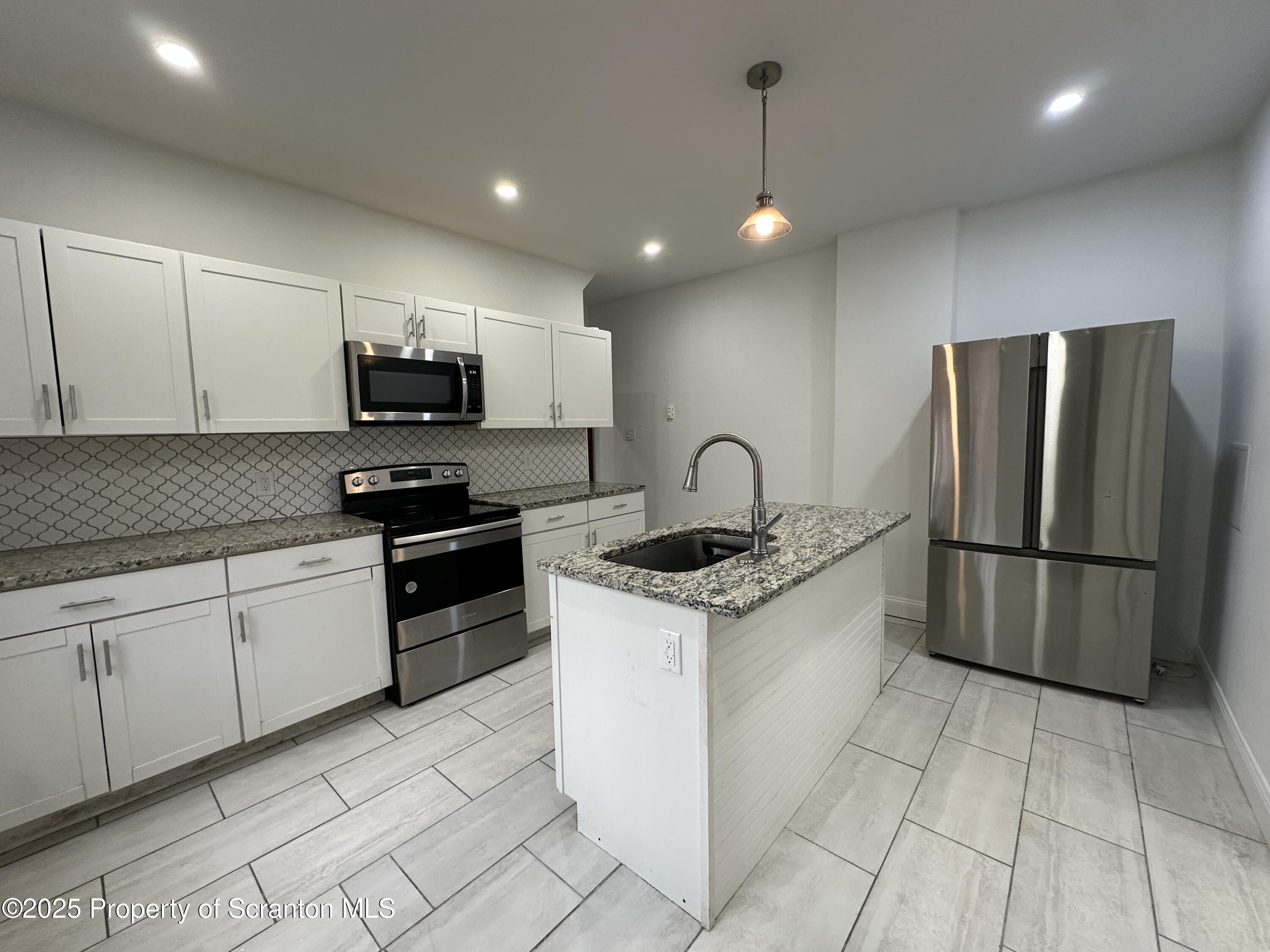 5 Robert Street Nanticoke, PA 18634 - Photo 1 of 26 a kitchen with stainless steel appliances granite countertop a stove a sink and a refrigerator