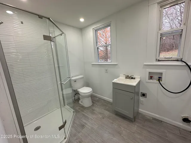 a bathroom with a toilet sink and a shower