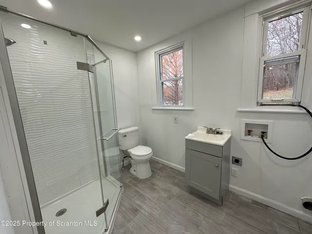 a bathroom with a toilet sink and shower