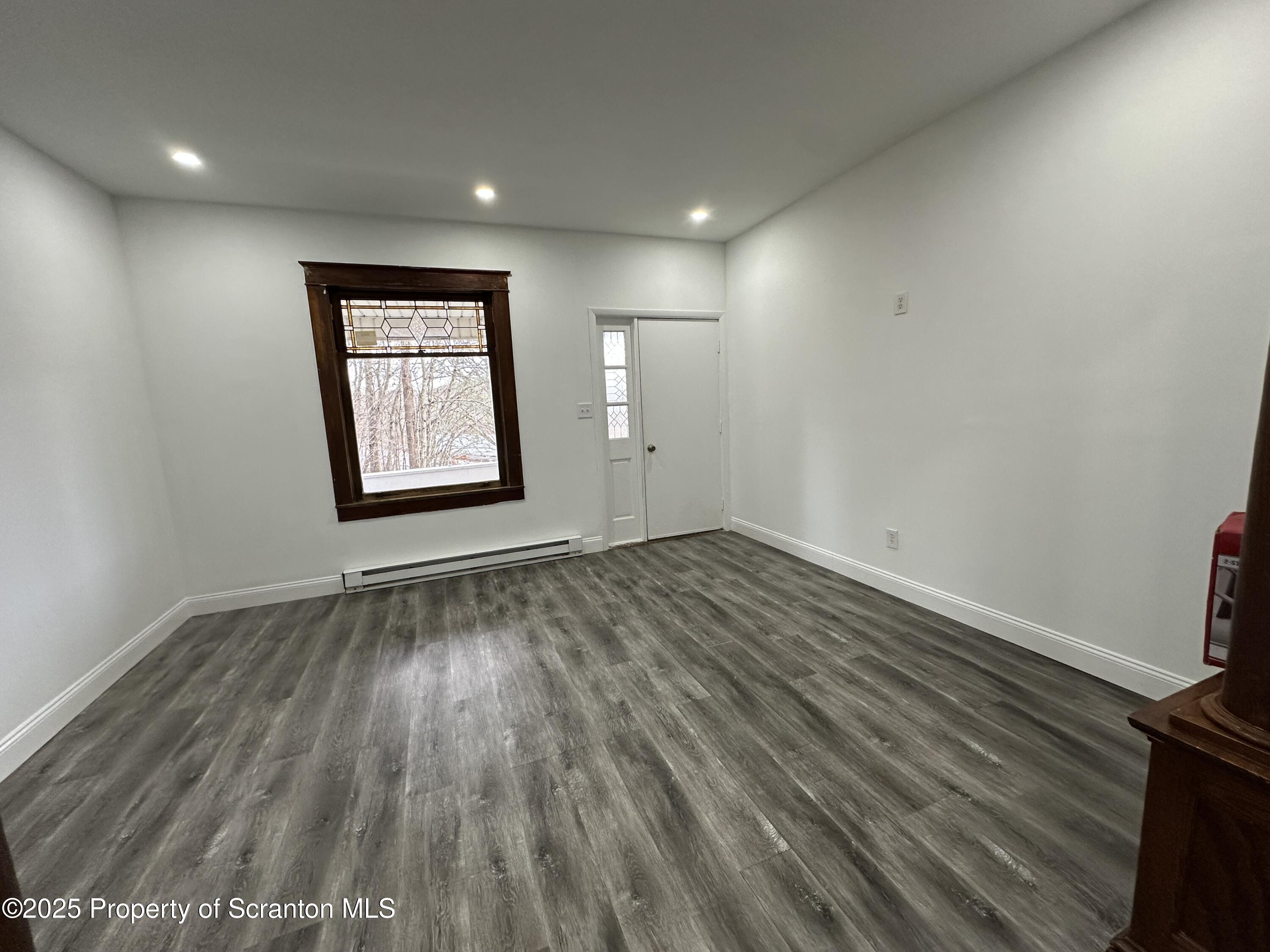 5 Robert Street Nanticoke, PA 18634 - Photo 5 of 26 an empty room with wooden floor and windows