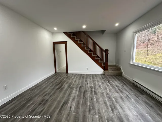 a view of entryway with wooden floor