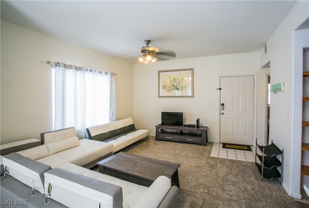 4655 Gold Dust Avenue, Unit 206 Las Vegas, NV 89120 - Photo 11 of 34 Carpeted living room featuring a ceiling fan