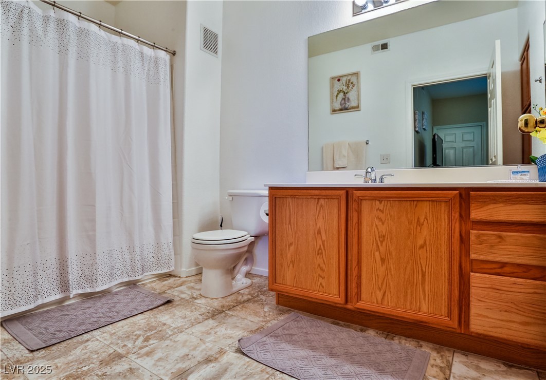 4655 Gold Dust Avenue, Unit 206 Las Vegas, NV 89120 - Photo 26 of 34 Full bathroom featuring vanity and a shower with curtain