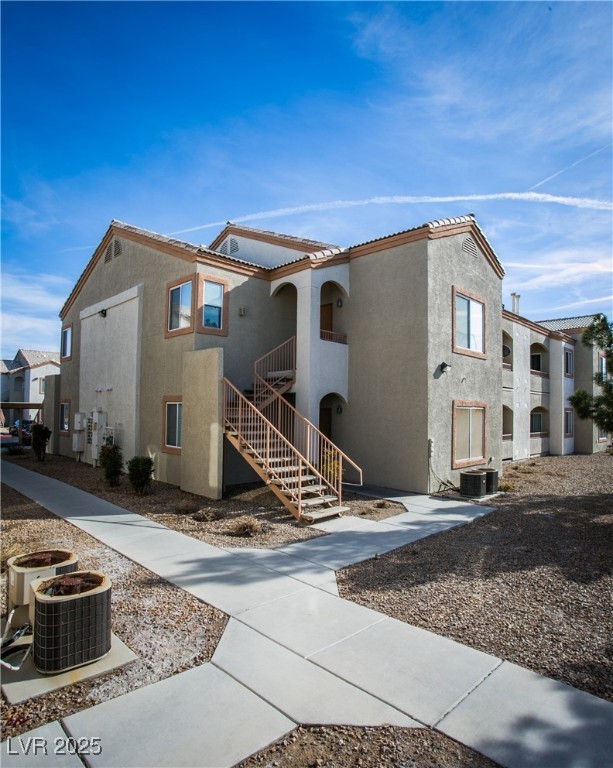 4655 Gold Dust Avenue, Unit 206 Las Vegas, NV 89120 - Photo 3 of 34 View of front of house with stucco siding, a tiled roof, and stairway