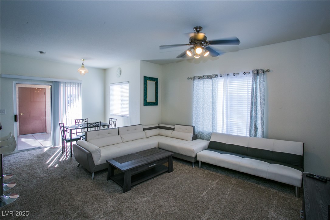 4655 Gold Dust Avenue, Unit 206 Las Vegas, NV 89120 - Photo 5 of 34 Living room featuring carpet and a ceiling fan