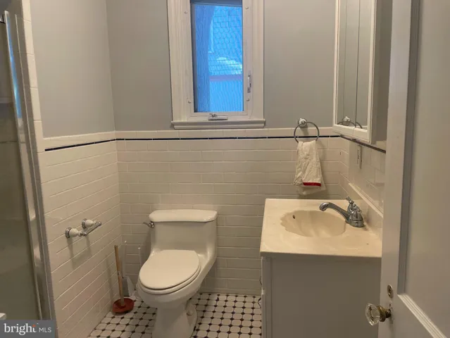 a bathroom with a sink toilet and mirror