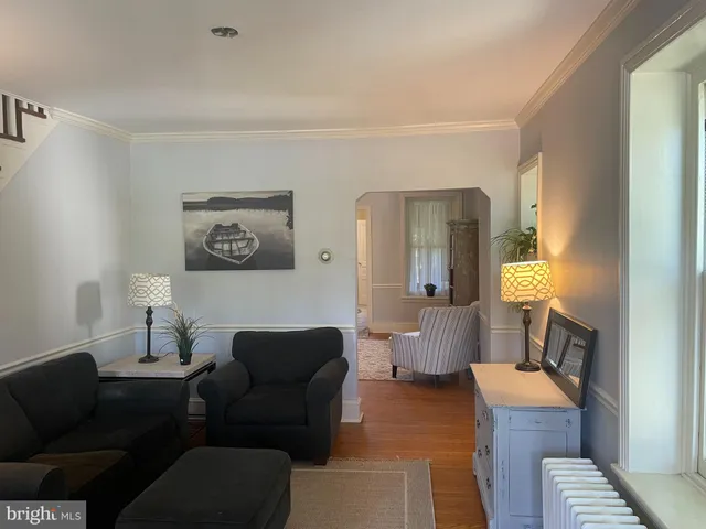 a living room with furniture and a lamp