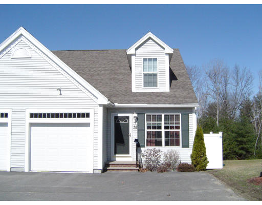 38 Brookview Road, Unit 38 Windham, NH 03087 - Photo 1 of 17 a front view of a house with a yard and garage