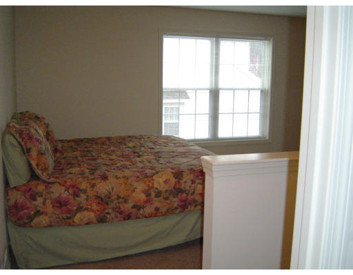 38 Brookview Road, Unit 38 Windham, NH 03087 - Photo 11 of 17 a bed sitting in a bedroom next to a window