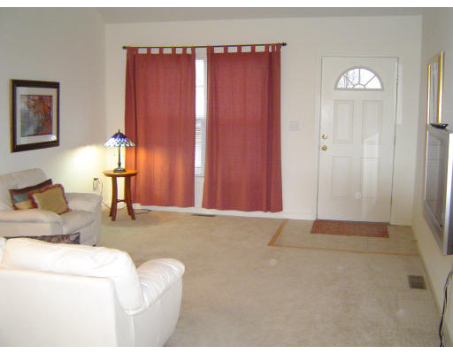 38 Brookview Road, Unit 38 Windham, NH 03087 - Photo 3 of 17 a living room with furniture and a window