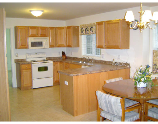 38 Brookview Road, Unit 38 Windham, NH 03087 - Photo 5 of 17 a kitchen with a table chairs sink and cabinets