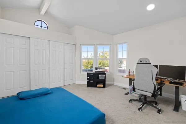 a view of a livingroom with workspace and a window