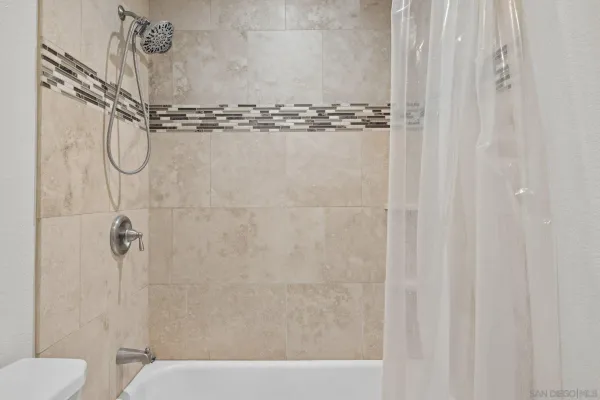 a bathroom with a shower and a toilet