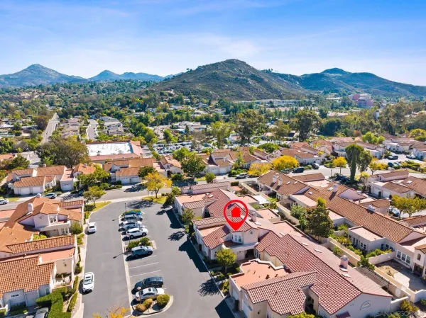 a view of a city with lots of residential buildings and mountain view in back