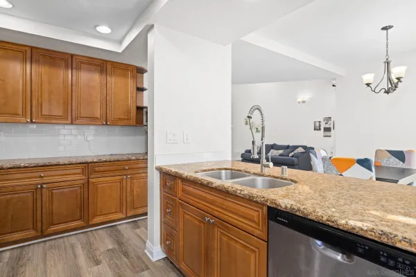 a kitchen with granite countertop a sink and cabinets