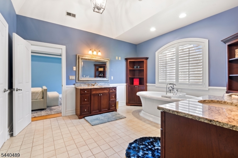 99 East Lindsley Road Cedar Grove, NJ 07009 - Photo 26 of 41 a spacious bathroom with a granite countertop sink mirror and a bathtub