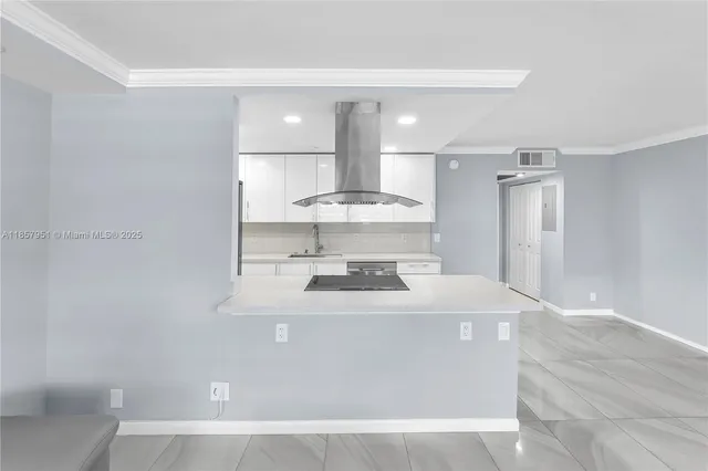 a view of kitchen with stainless steel appliances granite countertop white cabinets and refrigerator