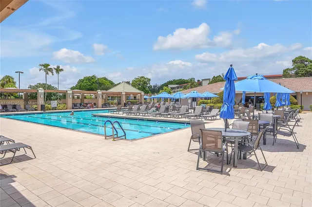 a view of a swimming pool with outdoor seating