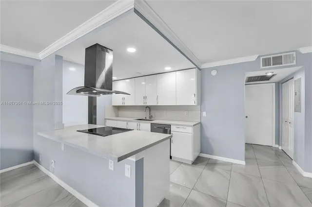 a kitchen that has a sink a stove and a refrigerator