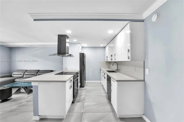 a kitchen with a sink a stove and a refrigerator