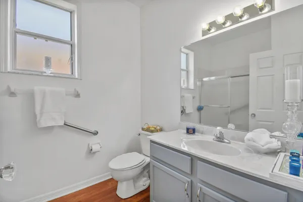 a bathroom with a sink vanity granite and toilet