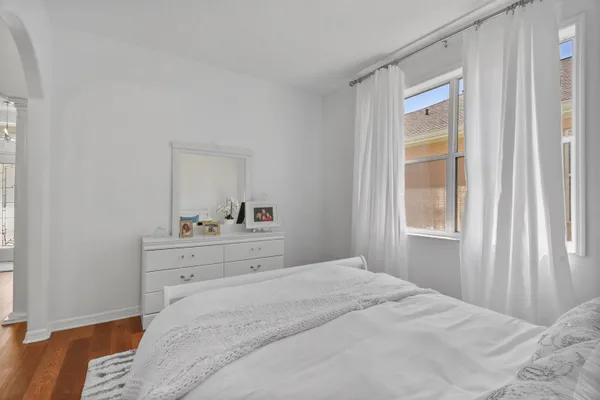 a bedroom with a bed and a window