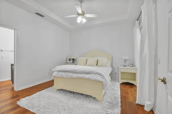 a bedroom with a bed and a chandelier