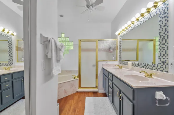 a bathroom with a sink double vanity and a shower