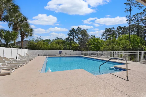 a view of a swimming pool with a lounge chair