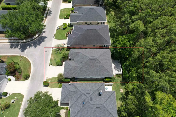 an aerial view of a house with yard