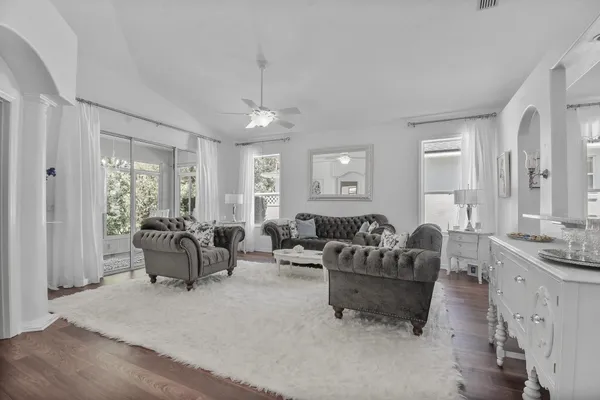 a living room with furniture and a chandelier