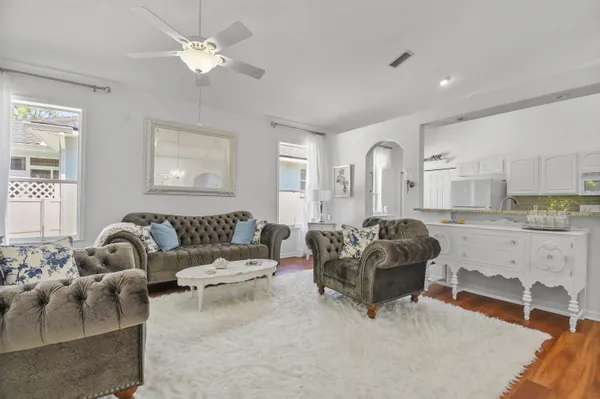 a living room with furniture and a chandelier