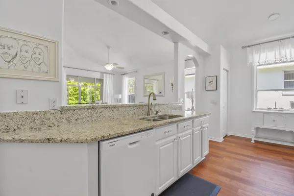 a bathroom with a granite countertop sink and a window