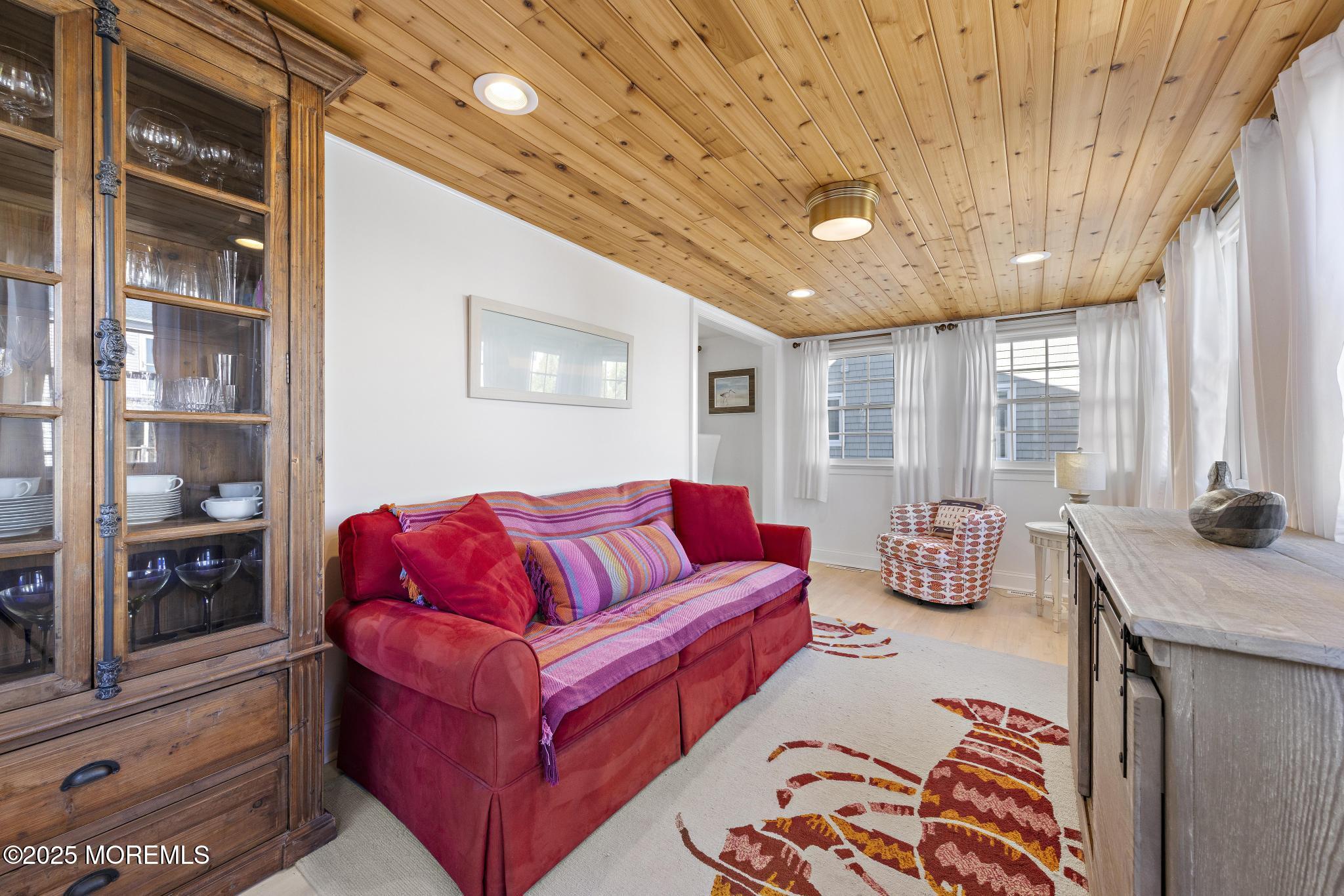 9 Inlet Road Beach Haven, NJ 08008 - Photo 14 of 51 a living room with furniture and a chandelier