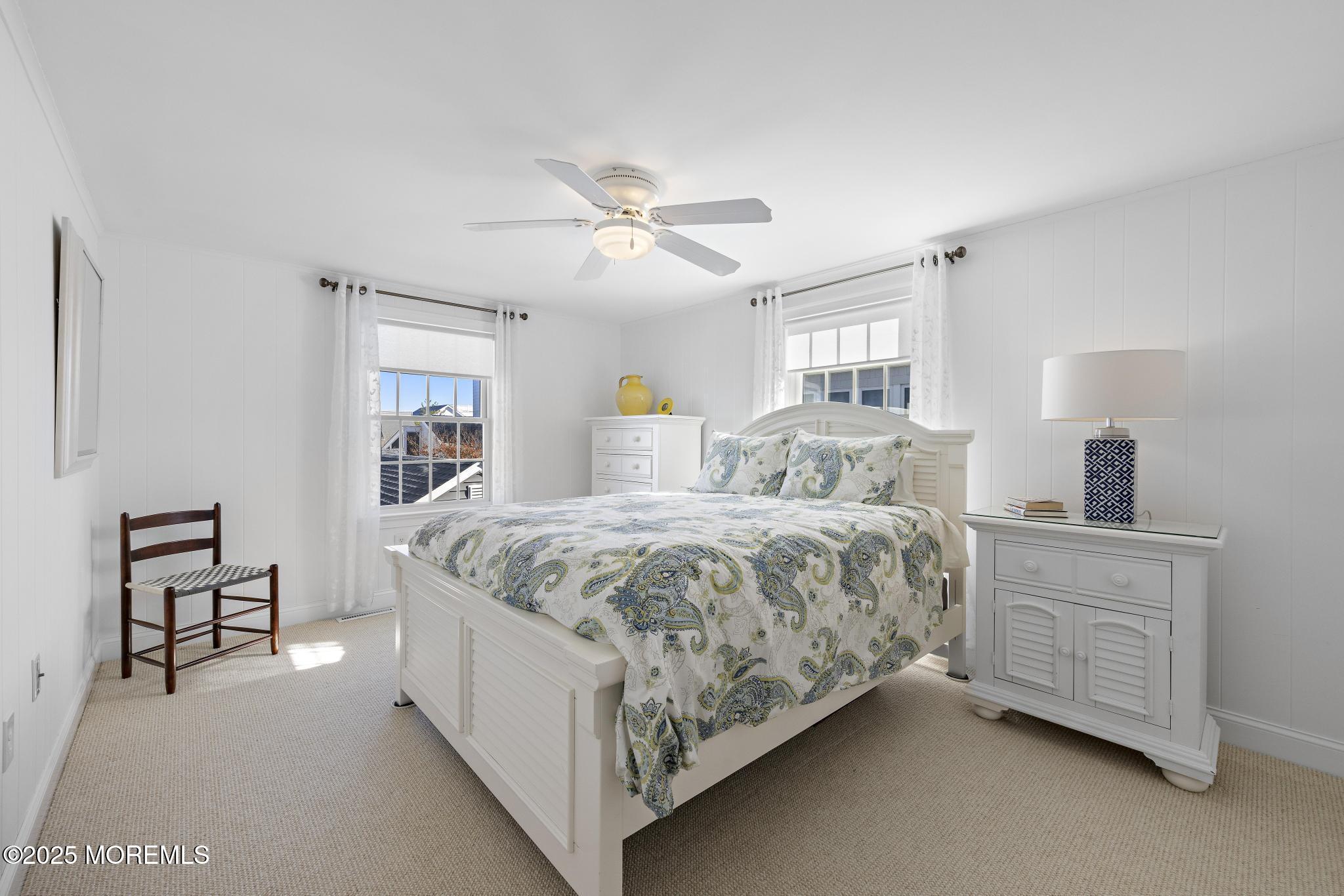 9 Inlet Road Beach Haven, NJ 08008 - Photo 19 of 51 a spacious bedroom with a large bed and a chandelier