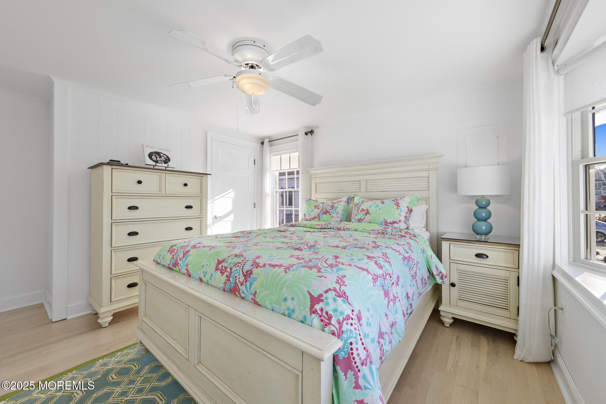 9 Inlet Road Beach Haven, NJ 08008 - Photo 21 of 51 a bedroom with a bed and a chandelier