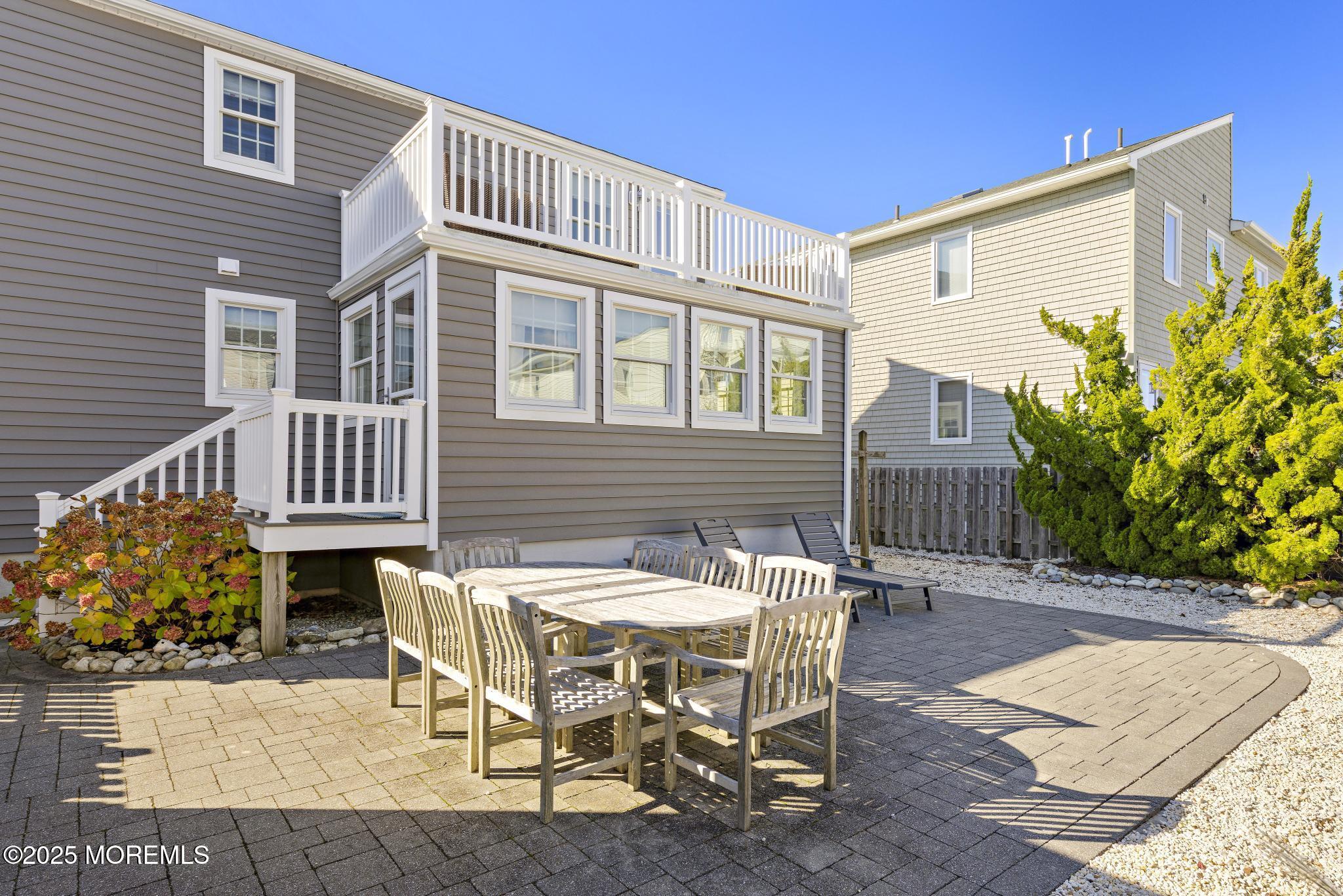 9 Inlet Road Beach Haven, NJ 08008 - Photo 35 of 51 a view of a patio with table and chairs with wooden floor and plants
