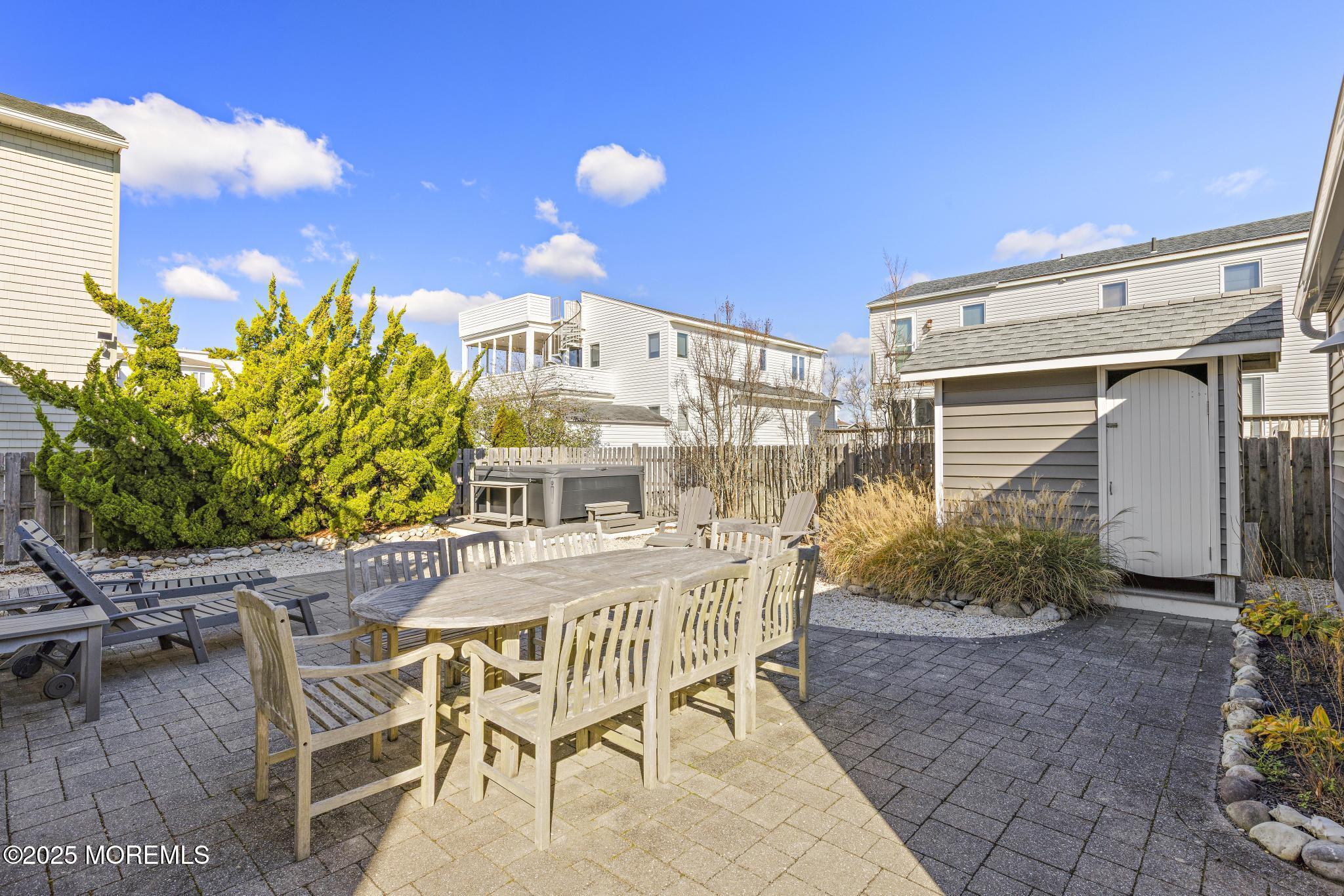 9 Inlet Road Beach Haven, NJ 08008 - Photo 36 of 51 a view of a patio with table and chairs and potted plants
