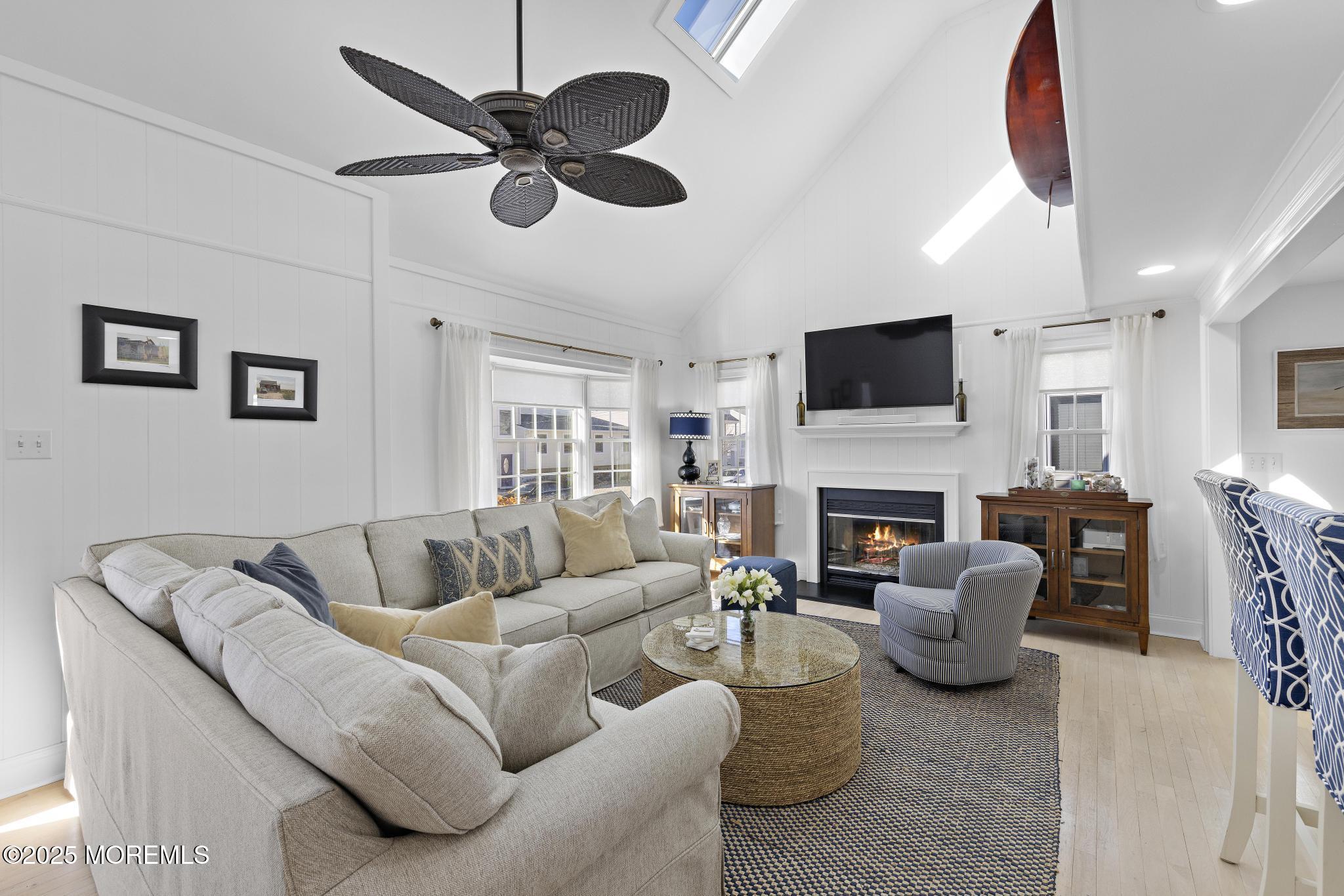 9 Inlet Road Beach Haven, NJ 08008 - Photo 4 of 51 a living room with furniture a fireplace and a flat screen tv
