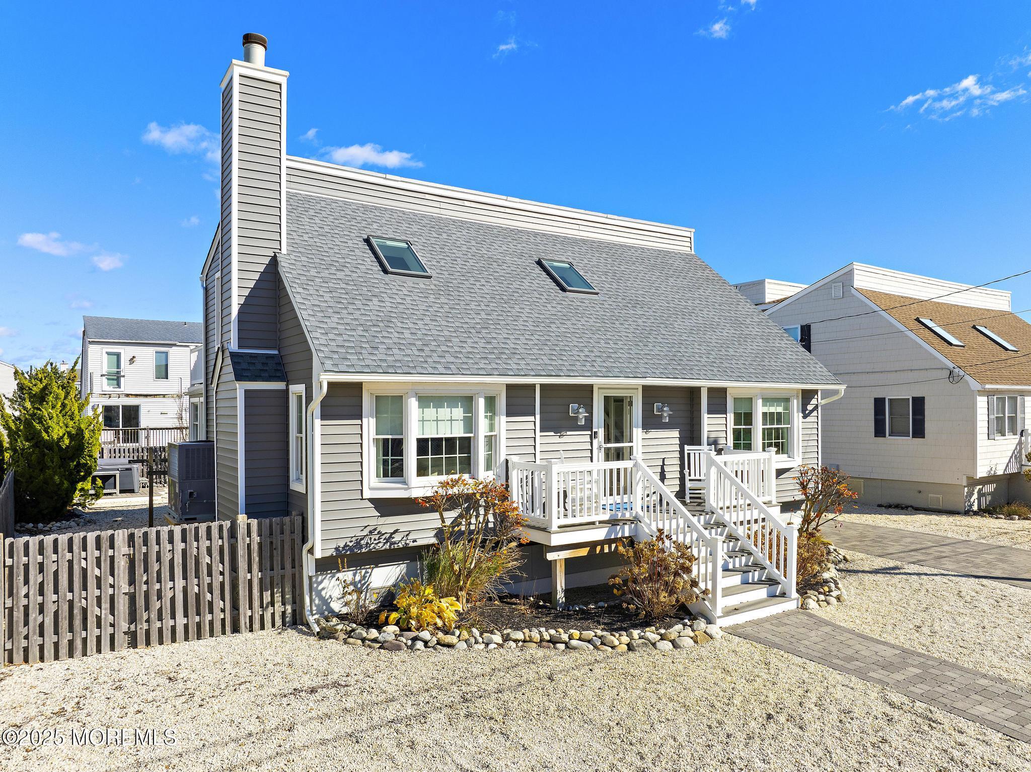 9 Inlet Road Beach Haven, NJ 08008 - Photo 49 of 51 a backyard of a house with table and chairs