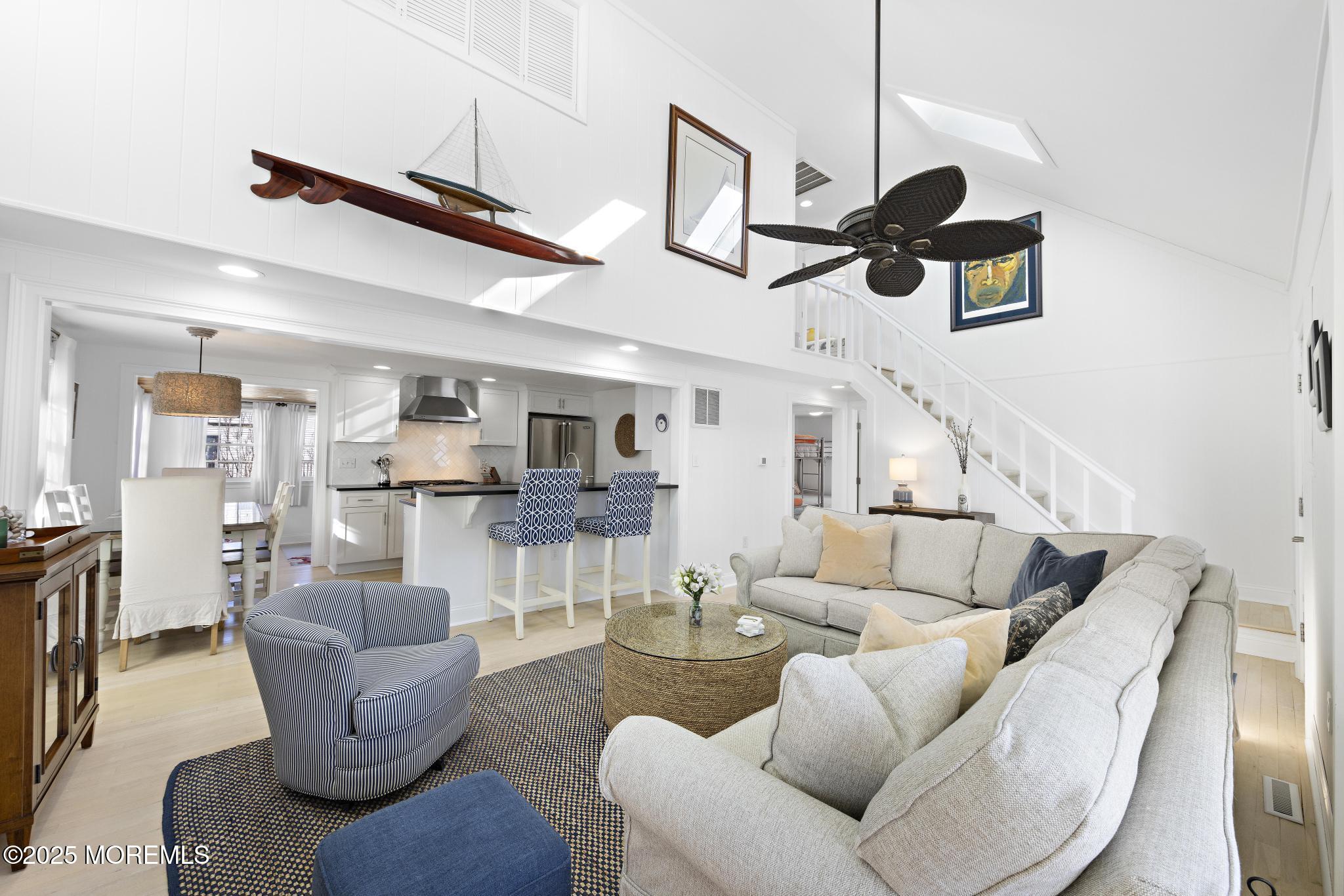 9 Inlet Road Beach Haven, NJ 08008 - Photo 5 of 51 a living room with furniture kitchen view and a chandelier