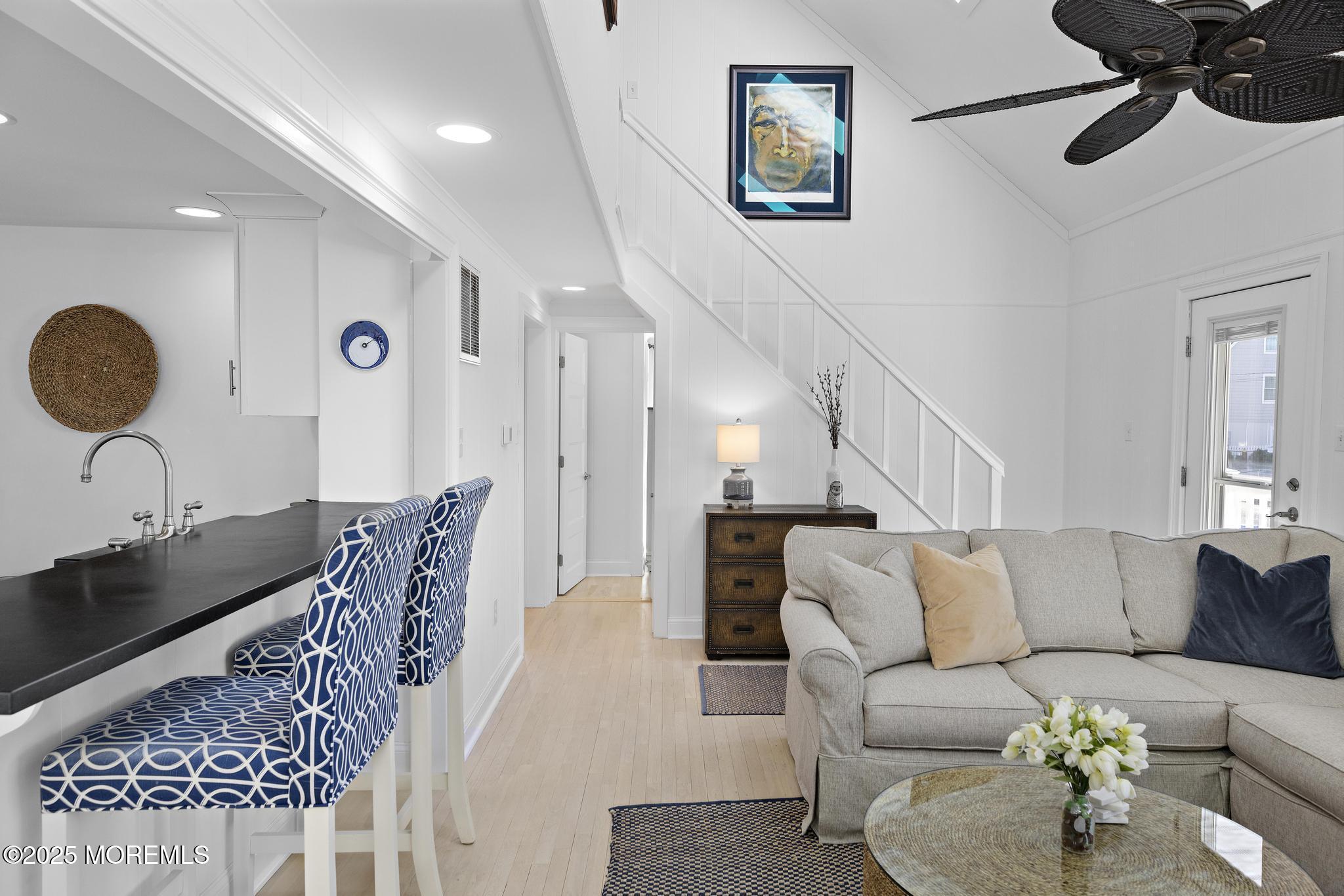 9 Inlet Road Beach Haven, NJ 08008 - Photo 7 of 51 a living room with furniture and a chandelier