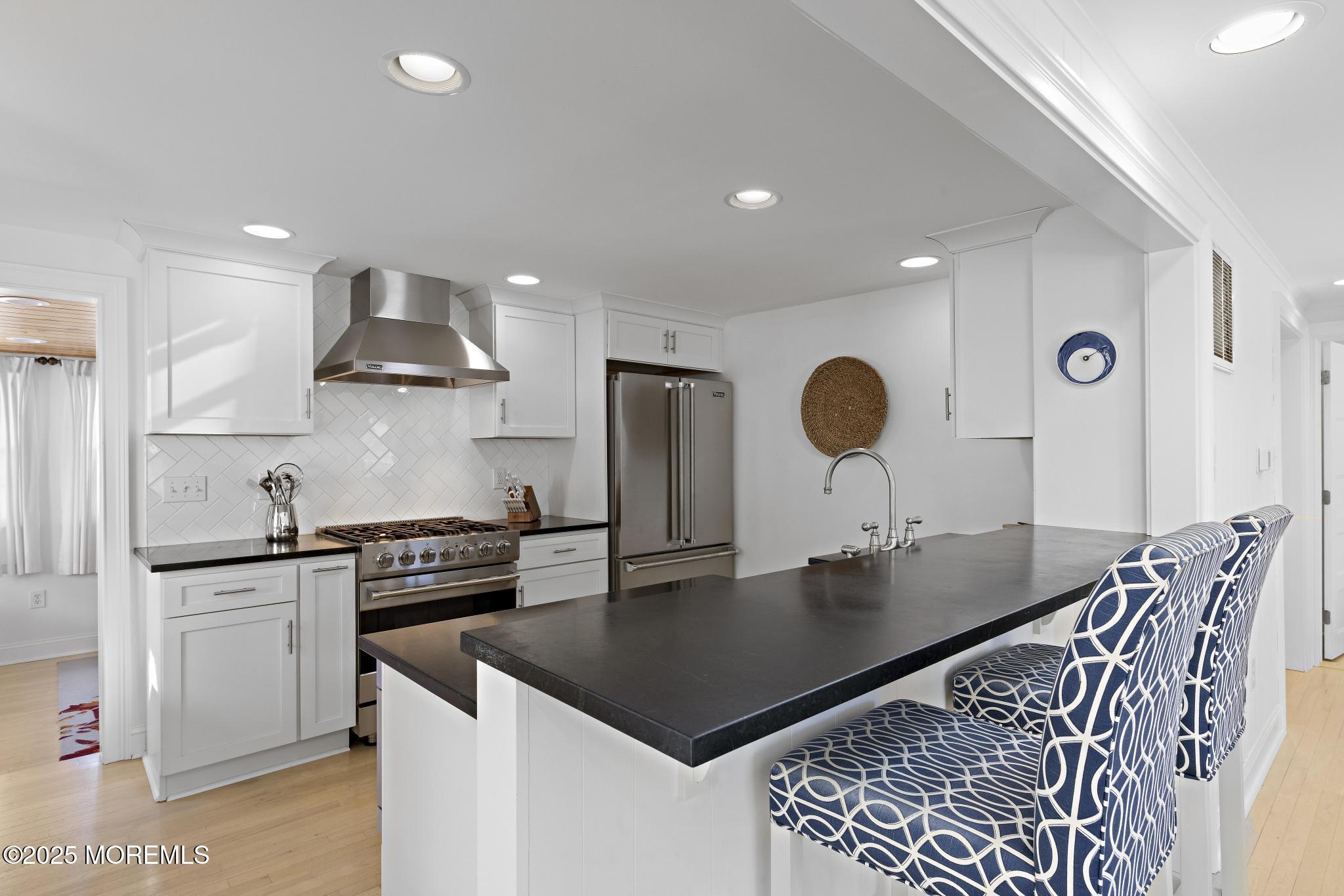 9 Inlet Road Beach Haven, NJ 08008 - Photo 9 of 51 a kitchen with stainless steel appliances granite countertop a sink a stove and a refrigerator