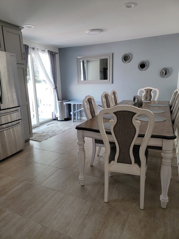 192 Starling Road Springfield, MA 01119 - Photo 12 of 26 a view of a dining room with furniture and a large window