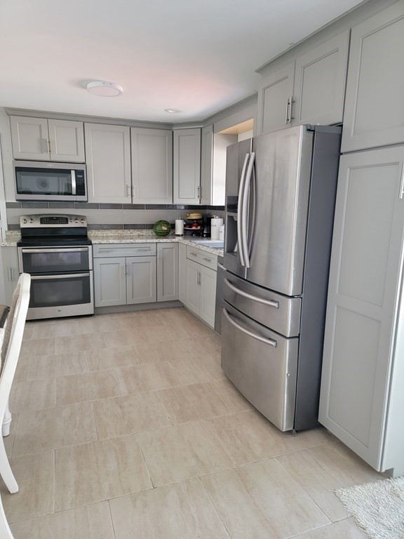 192 Starling Road Springfield, MA 01119 - Photo 13 of 26 a kitchen with cabinets stainless steel appliances and a window